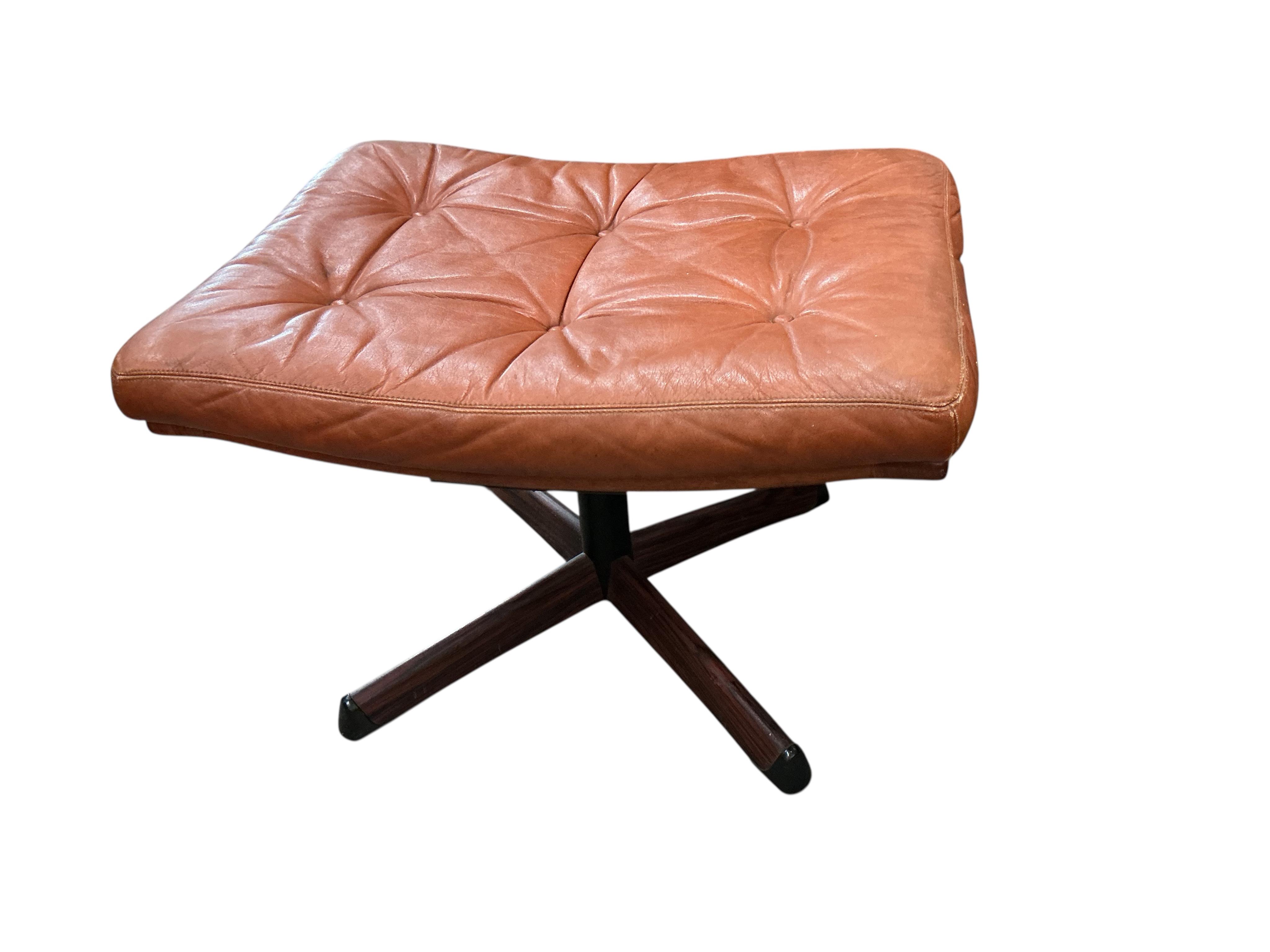 A mid century Swedish Gote Mobler leather swivel chair, width 74cm, depth 80cm, height 86cm and footstool
